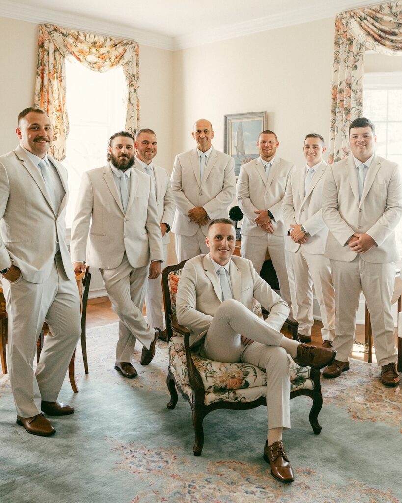 Posed portrait of all of the groomsmen inside the private estate