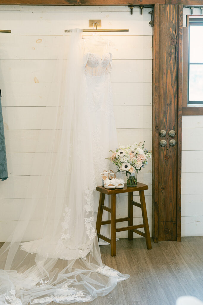wedding dress hung up against the shiplap wall